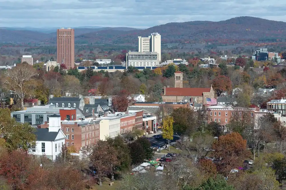 View over downtown Amherst, Massachusetts, with autumn trees and distant hills