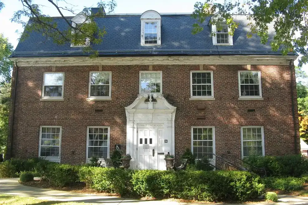 Brick Longmeadow Town Hall with a white entrance and dormers in Longmeadow, Massachusetts