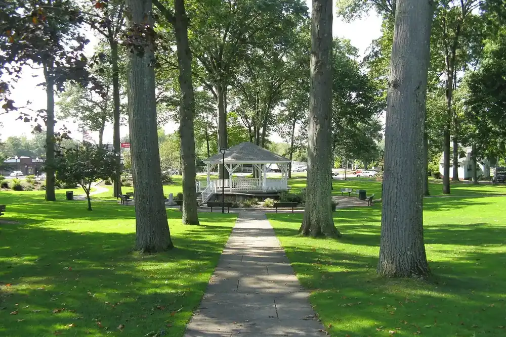 Shaded walking path leading to the gazebo on the Ludlow Town Green in Massachusetts