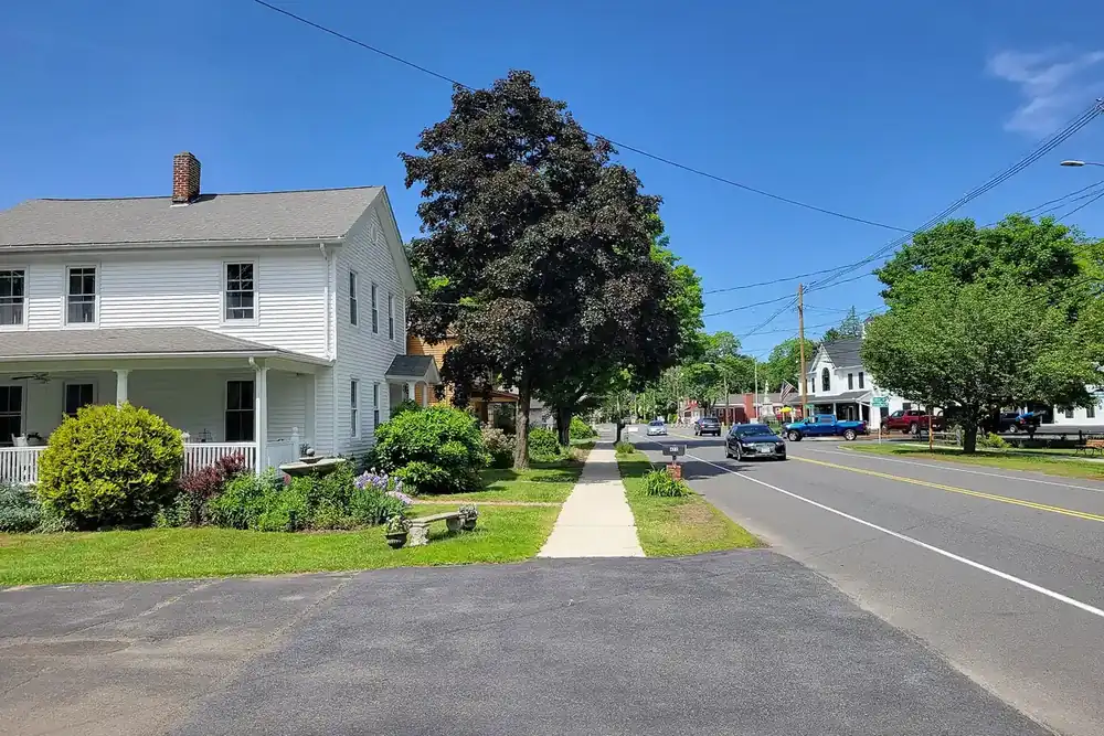 White clapboard house and sidewalk beside Main Street in Wilbraham, Massachusetts